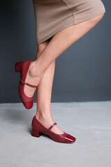 Red leather shoes on the female legs
