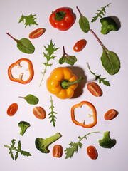 fresh healthy vegetables on a white background. pepper, broccoli, arugula, spinach, tomatoes