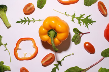 fresh healthy vegetables on a white background. pepper, broccoli, arugula, spinach, tomatoes