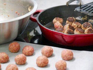 The process of making meatballs. Meatballs cooking in a cast irom pan on the stove. Fresh meatballs. Swedish meatballs, cuisine.