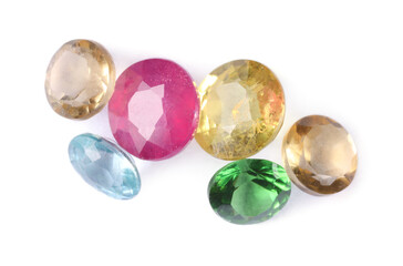 Different colorful shiny gemstones isolated on white