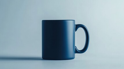 A cylindrical ceramic coffee mug in a matte navy blue, showcasing clean and simple aesthetics, isolated on white