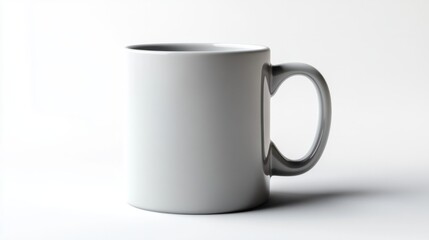 Fototapeta premium A short, wide ceramic coffee mug in a matte gray finish, blending modern and minimalist aesthetics, on a clean white background