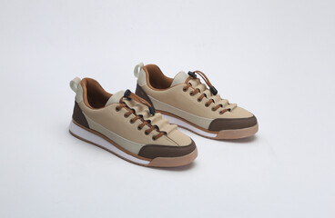 Beige brown and camel color trendy unisex sneakers isolated on white background
