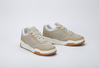 Beige brown and camel color trendy unisex sneakers isolated on white background
