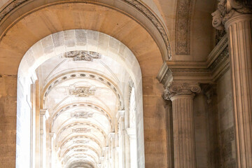 A long hallway features many arches and columns in a major building
