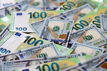 Obraz premium Big pile of Euro and USD banknotes. Many european and united states dollars