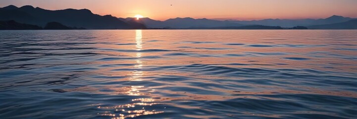 Fototapeta premium Gentle water surface with subtle ripples in a serene blue hue at dusk, blue water reflection, serene landscape