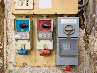OLD ELECTRICAL EQUIPMENT, PLUG SOCKET IN A CONTROL PANEL - Electric switchboard with power switches
