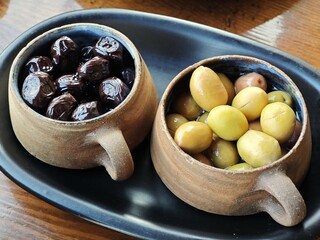 Black olives and green olives in cup potteries