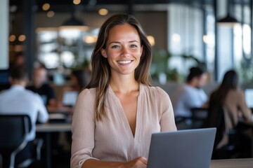 A cheerful young woman works on her laptop in a modern cafe environment, radiating positivity and engagement, perfectly blending productivity with casual ambiance.