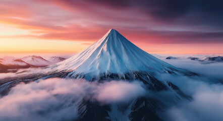 Fototapeta premium A majestic snow-capped mountain peaks above clouds during a vibrant sunset, showcasing nature's beauty and serenity.
