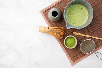 Traditional matcha kit, Bamboo whisk and beverage on bamboo mat in the kitchen
