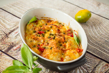 cauliflower baked with sweet pepper and vegetables under cheese