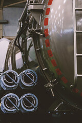 A close-up view of the rear of a large, industrial vacuum truck. The focus is on the large...