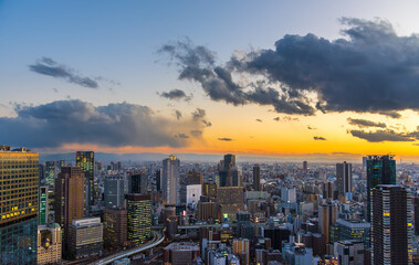 Cityscape of Osaka city Japan Umeda district skyline at sunset.