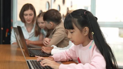Group of multiethnic children working or playing laptop, programing system. Happy funny diverse student working by using laptop to writing prompt or programing system. Smart classroom. Erudition. - Powered by Adobe