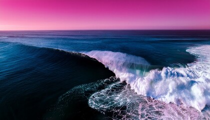 Aerial view of a wave cresting with white foam. for surfers in the black and pin background