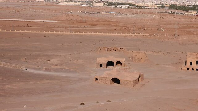 Ruins of ritual buildings next to Zoroastrian Dakhma Towers of Silence in Yazd city, Iran. Tourist walk around remains of Zoroastrians Dakhmeh Towers of Silence area in Yazd city.