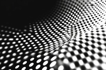 Abstract grayscale pattern; undulating, dotted surface.