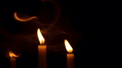 burning candle on black background