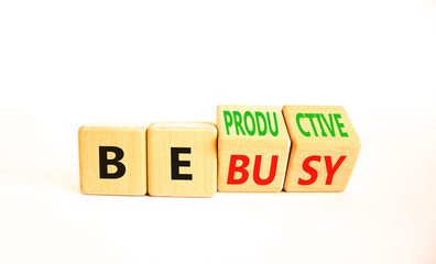 Be productive not busy symbol. Concept words Be productive Be busy on wooden block. Beautiful white table white background. Business be productive not busy concept. Copy space.