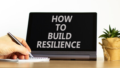 How to build resilience symbol. Concept words How to build resilience on beautiful black tablet. Beautiful white background. Businessman hand. Business and how to build resilience concept. Copy space.