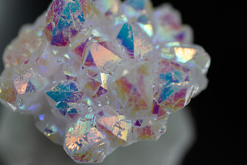A rainbow aura quartz crystal cluster radiates vibrant, iridescent hues, combining natural beauty with mystical energy and gemstone brilliance, isolated in studio