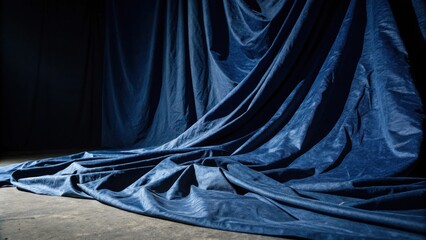 A dramatic blue curtain draped over a surface, creating a backdrop for a mysterious story.