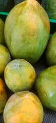 Fresh papayas displayed at a local market during the afternoon in a tropical region