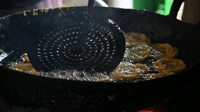 Jalebi making. It is a popular sweet snack in India subcontinent. It is many names&nbsp;jilapi,&nbsp;jilebi,&nbsp;jilipi,&nbsp;zulbia,&nbsp;mushabak,&nbsp;z&rsquo;labia and&nbsp;zalabia. Its made by maida flour&nbsp;batter&nbsp;and sugar syrup. 