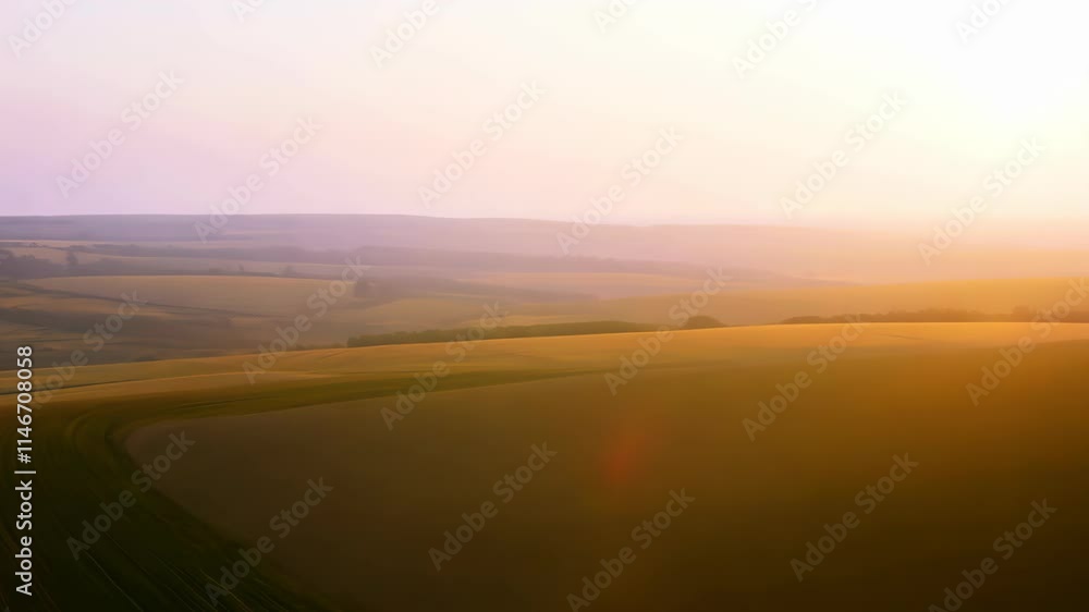 Poster exploring the serene landscapes of rolling hills and fields at dusk