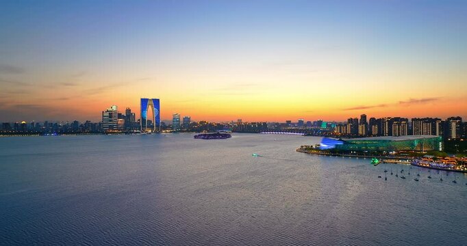 Aerial shot of modern city buildings with skyline and lake in Suzhou, China