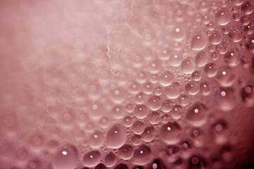 Close Up of Condensation Floating Liquid Water Bubbles and Drips on Glass from Rain