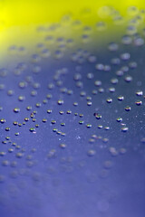 Close Up of Condensation Floating Liquid Water Bubbles and Drips on Glass from Rain