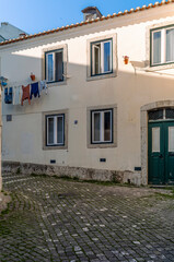 The narrow alleys and old buildings of the Alfama neighborhood in Lisbon in the late afternoon