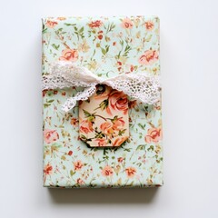 Beautifully Wrapped Gift Box with Floral Pattern and Lace Ribbon on a Soft White Background, Ideal for Celebrations and Special Occasions