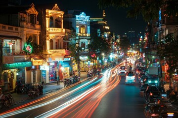 Naklejka premium Vibrant city street illuminated by festive lights on a busy night with vehicles and bustling atmosphere in an