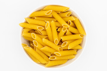 A bowl of uncooked penne pasta on a white background, showcasing its texture and golden color. Perfect for food, Italian cuisine, or cooking-related themes.