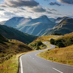 Fototapeta premium Winding rural road through mountains