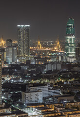 Night view after sunset of Skyscrapers in the business district and Bhumibol Bridge. Beautiful city of Bangkok with bright glowing lights in the sundown, use it as your Wallpaper, Poster andCopy space