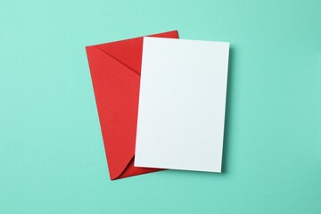 Paper card with envelope on color background. Empty greeting card for text design