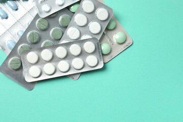 Various blisters with tablets on a colored background