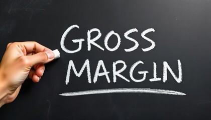 Fototapeta premium Hand holding white chalk writing Gross Margin.Highlighting key business principles.