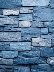 A close-up of a textured blue stone wall, showcasing its natural patterns and colors.