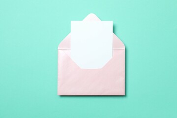 Paper card with envelope on color background. Empty greeting card for text design