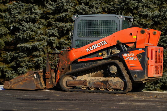 Orange Kubota SVL75-2 track loader sits unused. 