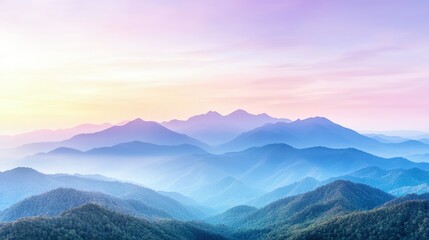 Fototapeta premium Misty blue mountain ridges layers under a pastel purple and pink sunrise sky.