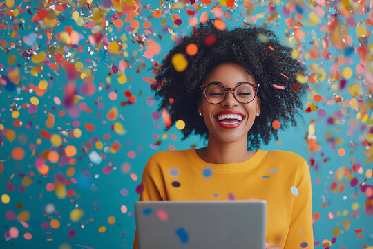woman is smiling and holding a laptop in front of a colorful background. Concept of joy and excitement, possibly related to a celebration or a happy moment