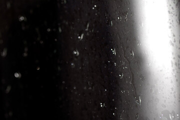 Close Up of Heavy Rain Floating Liquid Water Bubbles and Drips Black Background